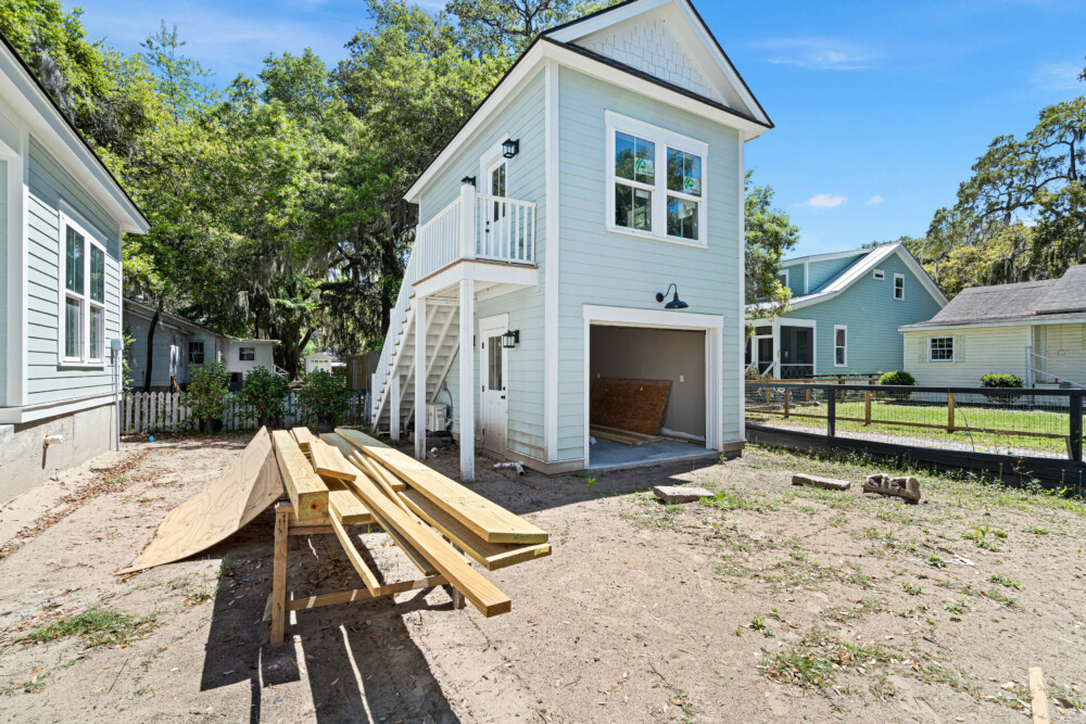 Spacious single-family house exterior with driveway, porch, and garden area.