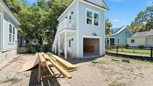 Spacious single-family house exterior with driveway, porch, and garden area.