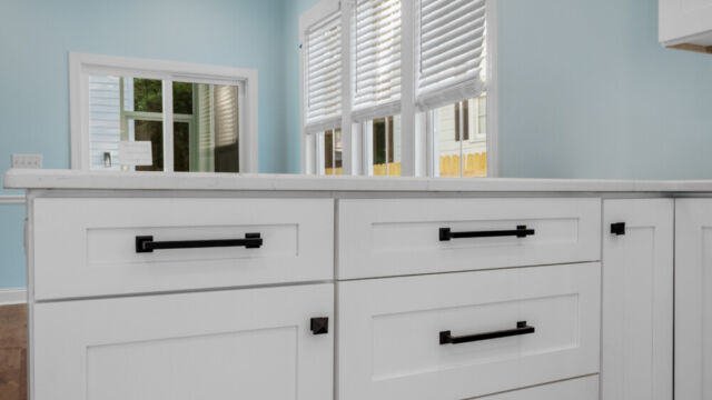 Spacious kitchen with clean lines, countertops, and modern appliances.