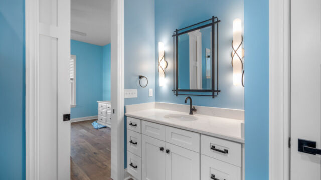 Spacious bathroom featuring a bathtub, vanity, and sleek contemporary fixtures.