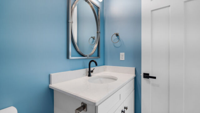 Spacious bathroom featuring a bathtub, vanity, and sleek contemporary fixtures.