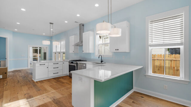 Spacious kitchen with clean lines, countertops, and modern appliances.