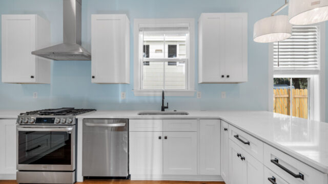 Spacious kitchen with clean lines, countertops, and modern appliances.