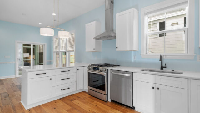 Spacious kitchen with clean lines, countertops, and modern appliances.
