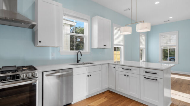 Spacious kitchen with clean lines, countertops, and modern appliances.