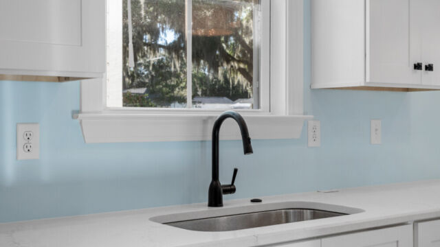 Spacious kitchen with clean lines, countertops, and modern appliances.