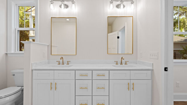 Primary bathroom featuring a classic clawfoot tub, vanity, and elegant finishes.