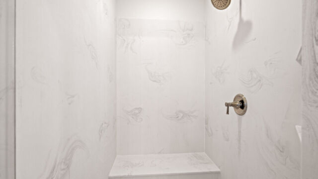 Primary bathroom featuring a classic clawfoot tub, vanity, and elegant finishes.