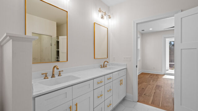 Primary bathroom featuring a classic clawfoot tub, vanity, and elegant finishes.