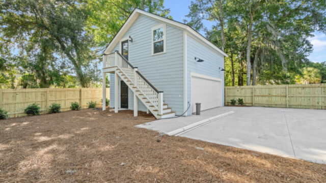 Spacious house exterior highlighting materials, windows, and surrounding greenery.