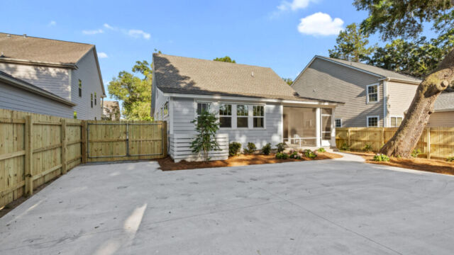 Spacious house exterior highlighting materials, windows, and surrounding greenery.