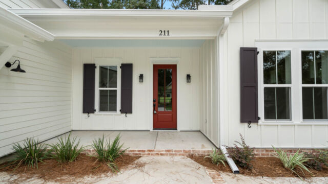 Modern residential exterior with clean lines, neutral finishes, and landscaped grounds.