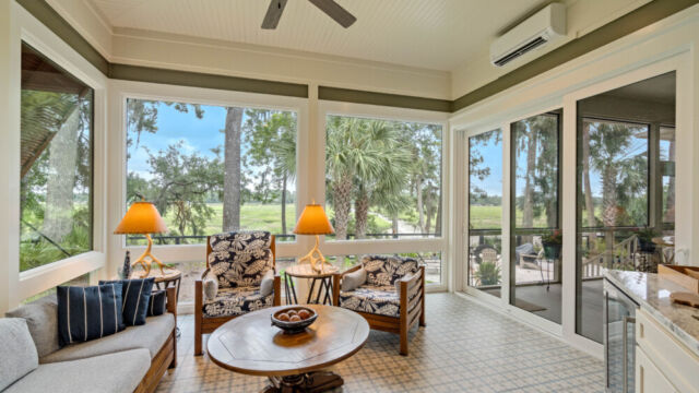 Sunroom addition to a home, featuring large windows and stylish architectural details.