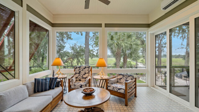 Sunroom addition to a home, featuring large windows and stylish architectural details.