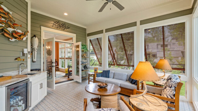 Sunroom addition to a home, featuring large windows and stylish architectural details.
