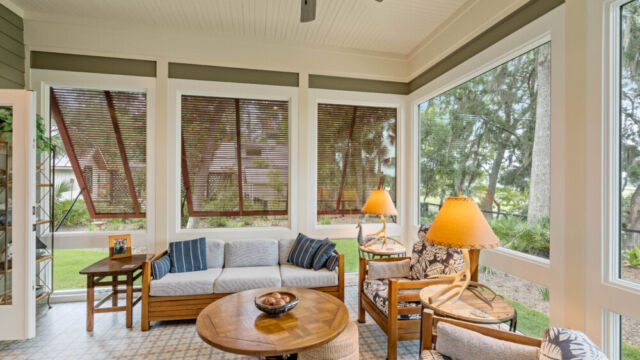 Sunroom addition to a home, featuring large windows and stylish architectural details.
