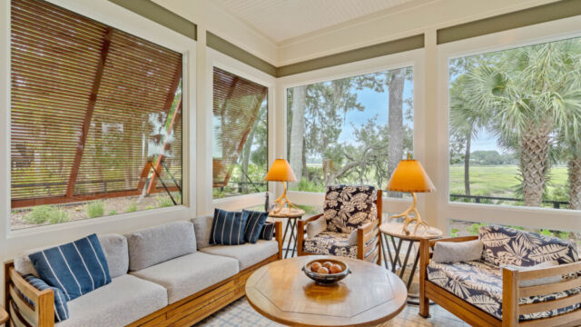 Sunroom addition to a home, featuring large windows and stylish architectural details.