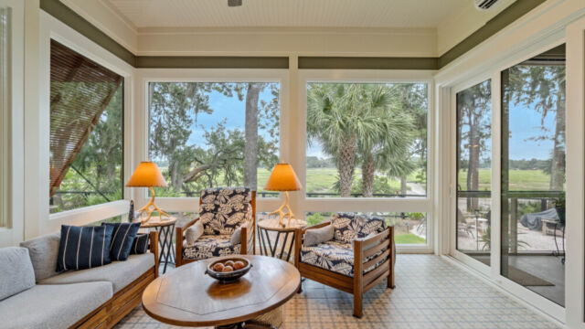 Sunroom addition to a home, featuring large windows and stylish architectural details.