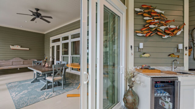 Sunroom addition to a home, featuring large windows and stylish architectural details.