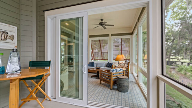 Sunroom addition to a home, featuring large windows and stylish architectural details.