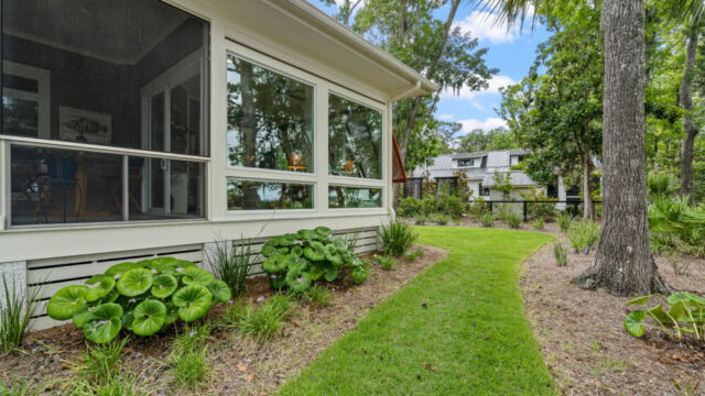 Sunroom addition to a home, featuring large windows and stylish architectural details.