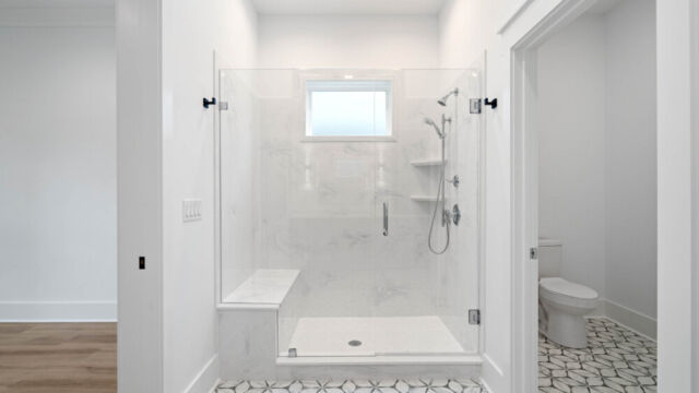 Bright and spacious bathroom with tile floors, countertop sinks, and modern accents.