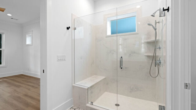 Bright and spacious bathroom with tile floors, countertop sinks, and modern accents.