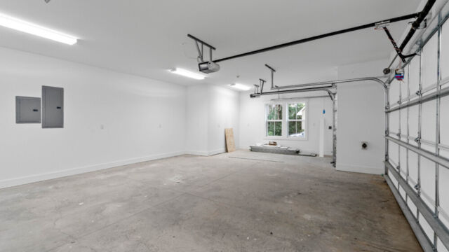 Spacious garage with an additional area for a golf cart.