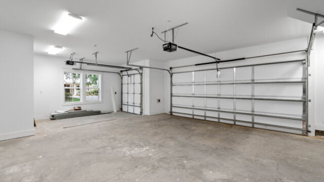 Spacious garage with an additional area for a golf cart.