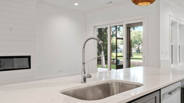 Contemporary open kitchen with central island, cabinetry, and high-end finishes.