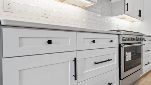 Contemporary open kitchen with central island, cabinetry, and high-end finishes.