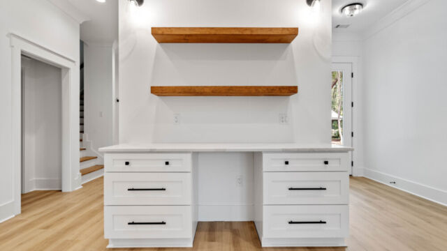 Contemporary open kitchen with central island, cabinetry, and high-end finishes.