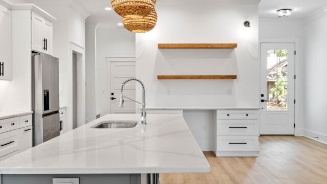 Contemporary open kitchen with central island, cabinetry, and high-end finishes.