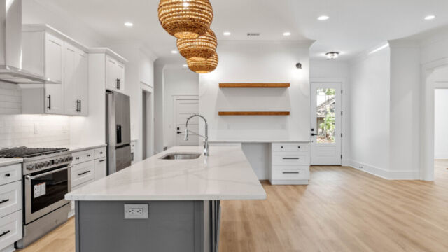 Contemporary open kitchen with central island, cabinetry, and high-end finishes.