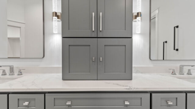 Spacious primary bathroom with tile floors, double vanity, and modern fixtures.