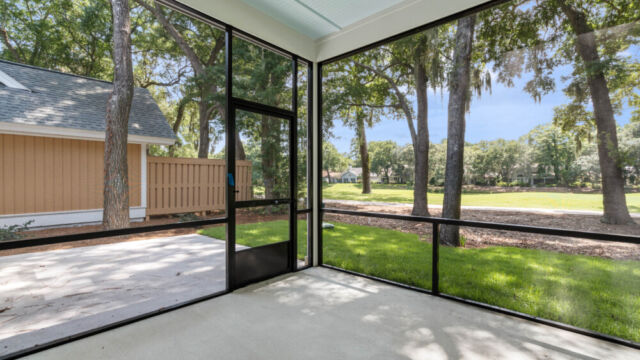 Bright and airy screened porch offering outdoor living with insect protection."