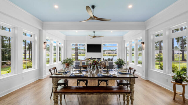 Sunroom addition to a home, featuring large windows and stylish architectural details.
