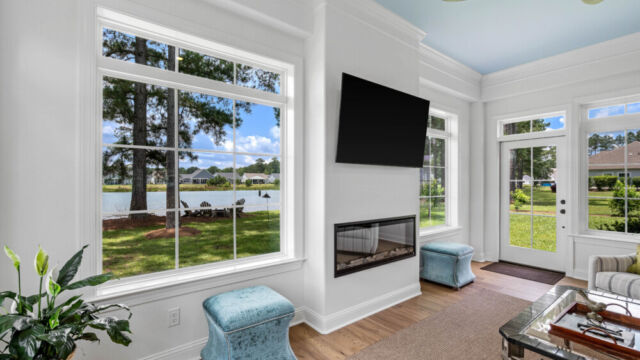 Sunroom addition to a home, featuring large windows and stylish architectural details.