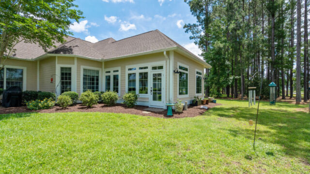 Sunroom addition to a home, featuring large windows and stylish architectural details.