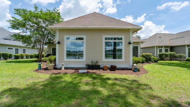 Sunroom addition to a home, featuring large windows and stylish architectural details.