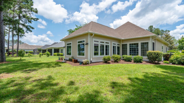 Sunroom addition to a home, featuring large windows and stylish architectural details.