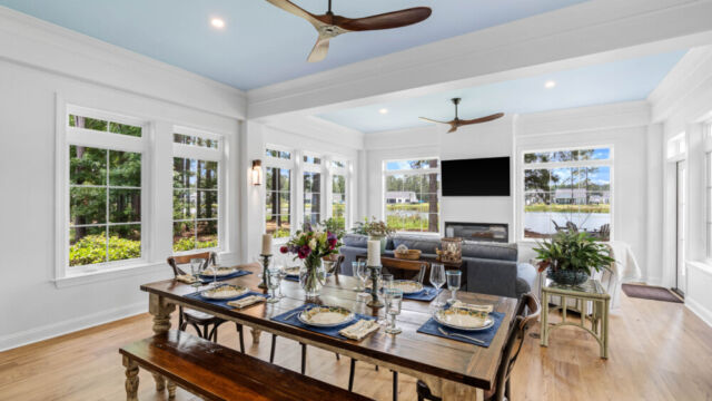 Sunroom addition to a home, featuring large windows and stylish architectural details.
