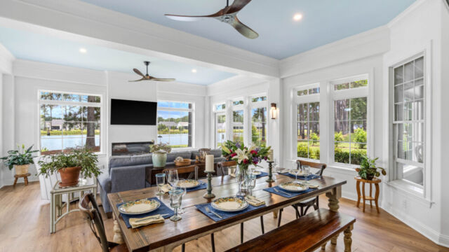 Sunroom addition to a home, featuring large windows and stylish architectural details.