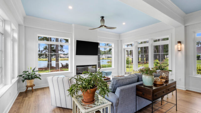 Sunroom addition to a home, featuring large windows and stylish architectural details.