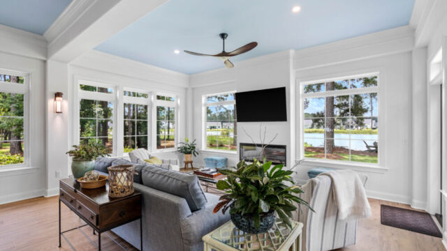 Sunroom addition to a home, featuring large windows and stylish architectural details.