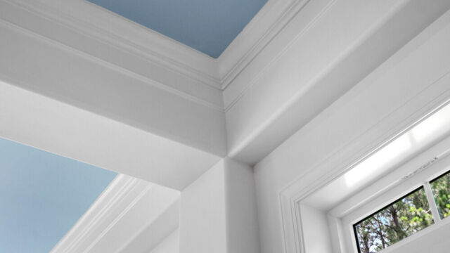 Sunroom addition to a home, featuring large windows and stylish architectural details.