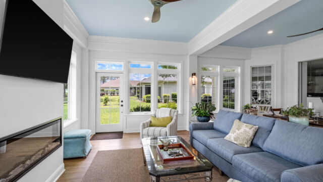 Sunroom addition to a home, featuring large windows and stylish architectural details.