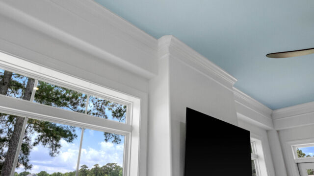 Sunroom addition to a home, featuring large windows and stylish architectural details.