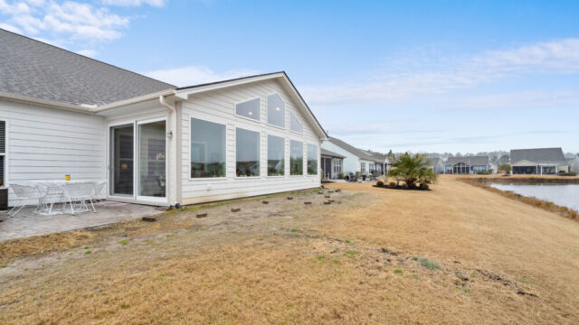 Bright custom sunroom with floor-to-ceiling windows, designed as a comfortable indoor-outdoor living space filled with natural light