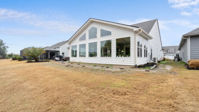 Bright custom sunroom with floor-to-ceiling windows, designed as a comfortable indoor-outdoor living space filled with natural light